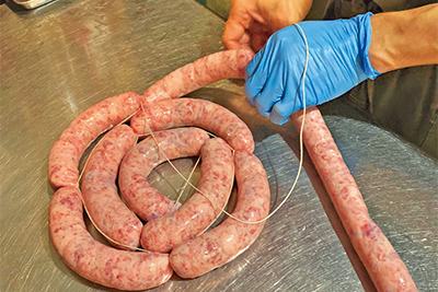 丁寧に下処理した新鮮な豚肉をミンチにし、塩やスパイスなどと合わせてこね、腸詰めにして成形します