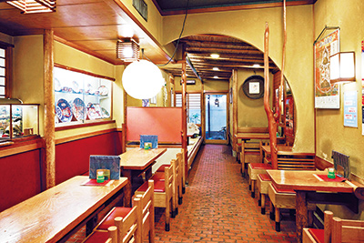 奥行きのある店内は椅子席のほか、畳敷きの小上がりも。陳列ケースに飾られる古伊万里の皿や丼は、器好きだったという初代のコレクション